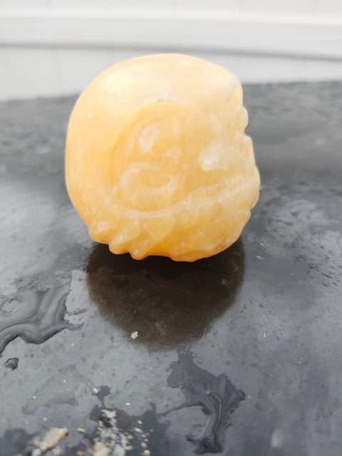 Orange calcite gnome carving