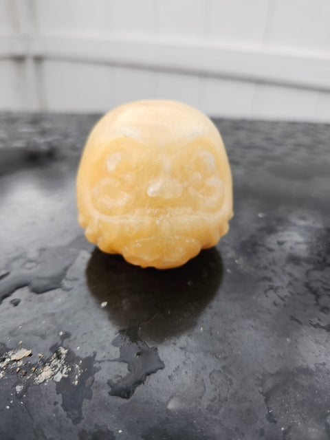 Orange calcite gnome carving