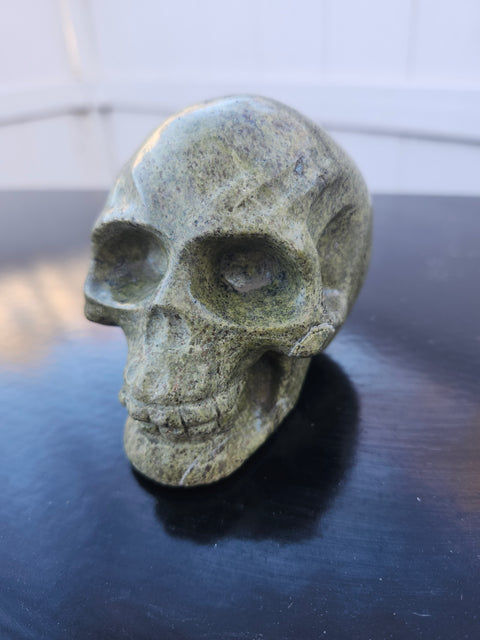 Epidote skull carving