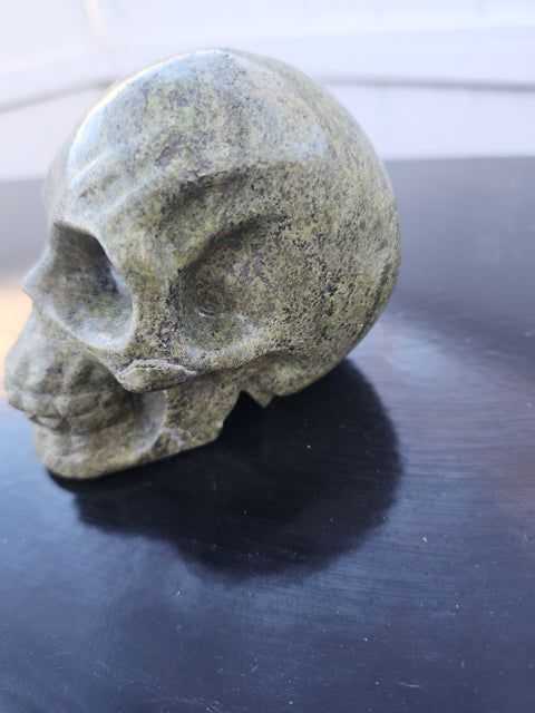 Epidote skull carving