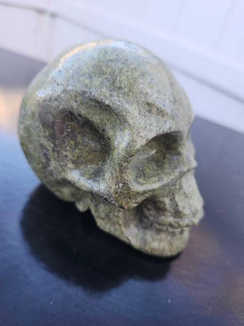 Epidote skull carving